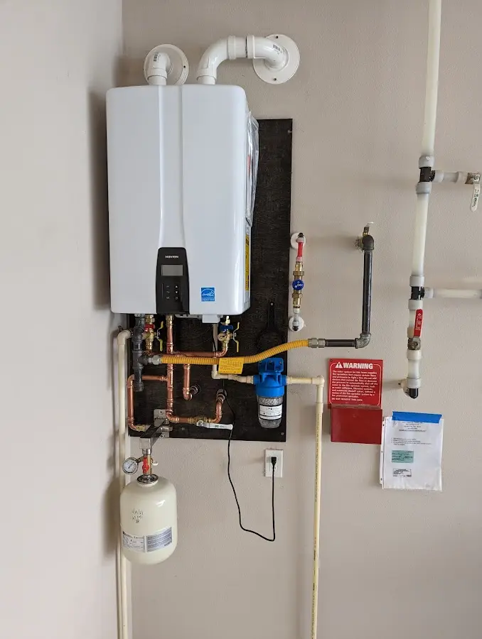 Professional plumber installing copper piping in a Offutt AFB home